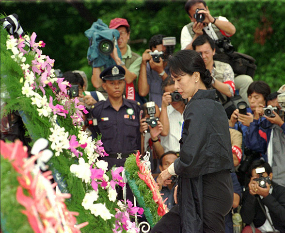 Aung San Suu Kyi release: 1995: Aung San Suu Kyi looks at wreaths laid at the Martyrs' Mausoleum