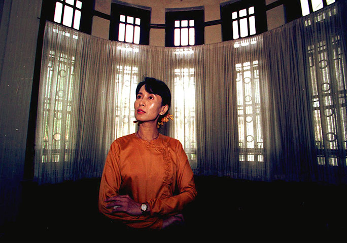 Aung San Suu Kyi release: 1996: Aung San Suu Kyi sits at the window of her residence in Rangoon