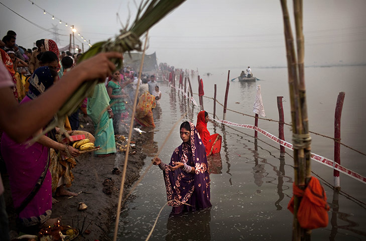 24 Hours: Indian woman from the state of Bihar offers prayers in the Yamuna River