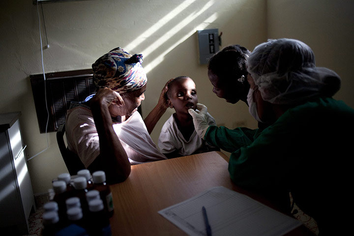 Haiti cholera: Doctors assist a boy suffering cholera symptoms at the hospital in Arcahie