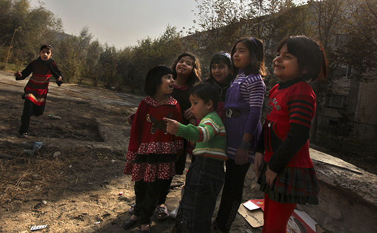 Eid al-Adha: Afghan children watch as butchers, unseen, slaughter a sheep