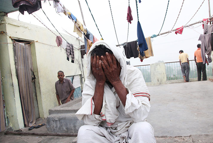 24 hours in pictures: Sixty killed in building collapse in New Delhi