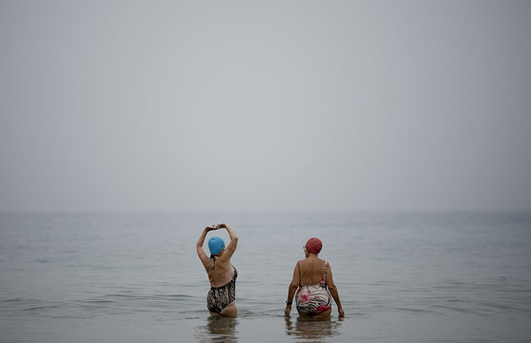 24 hours in pictures: Tel Aviv, Israel: Bathers in the Mediterranean sea