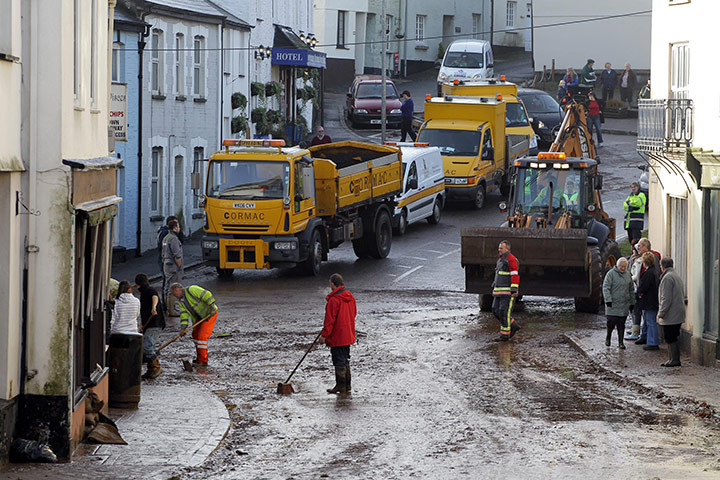 cornwall flooding: Council workers clean the flooded streets in Lostwithiel