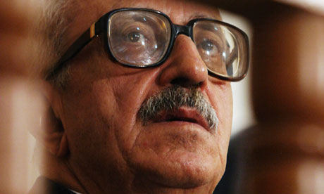 Tariq Aziz listens to a list of charges in a court in Baghdad in  2004