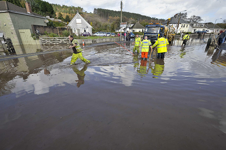 cornwall flooding update: Workmen try to clear a drain in St Blazey