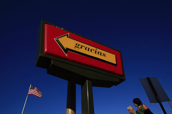 Eric Thayer : People walk towards a McDonalds near the San Luis Port of Entry