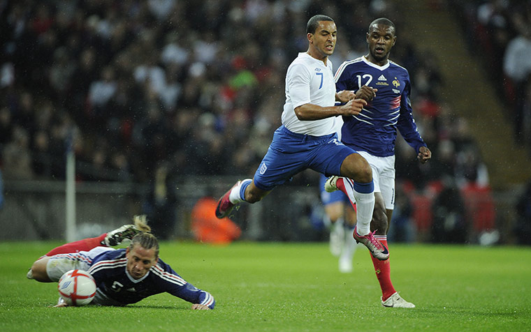England v France: Walcott is tackled by Mexes