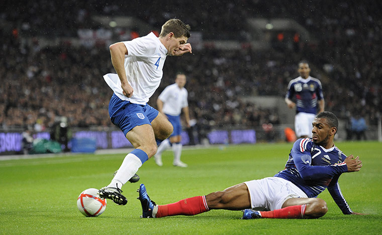 England v France: Gerrard gets out of the way of the sliding boot of M'Vila