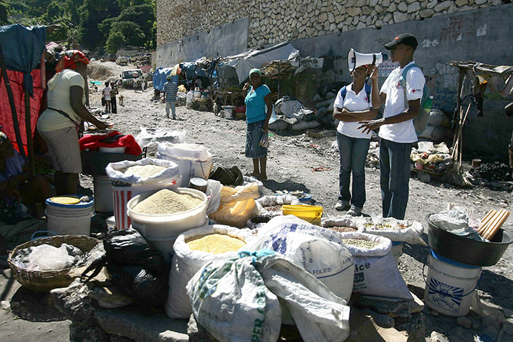 Haiti Cholera Devastation: A member of the Haitian Red Cross gives instructions on hygiene