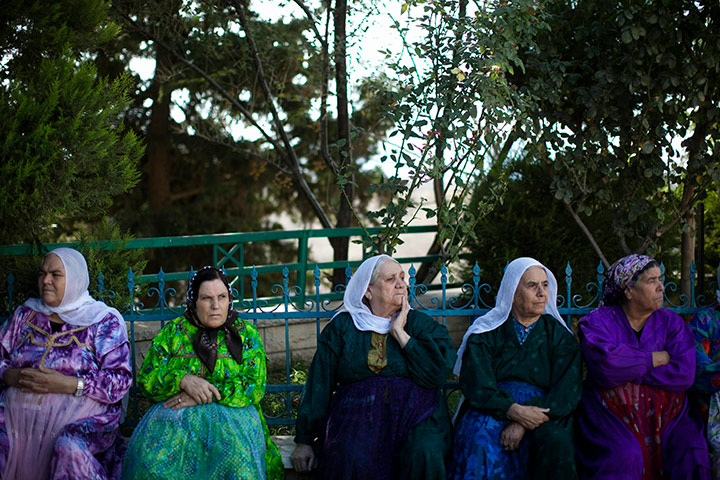 24 hours in pictures: ocal women sit in the village of Ghajar