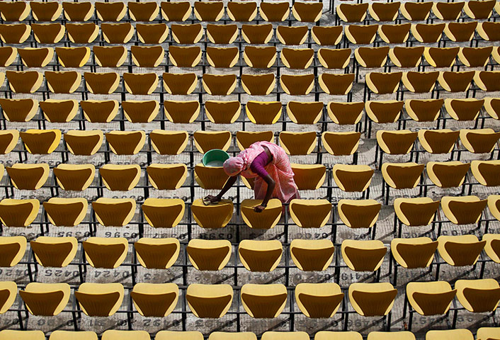 24 hours in pictures: A worker cleans the seats of Vidarbha cricket association stadium in Nagpur