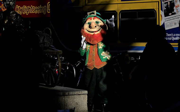 Week in Business: A man dressed as a leprechaun entertains people in Dublin, Ireland