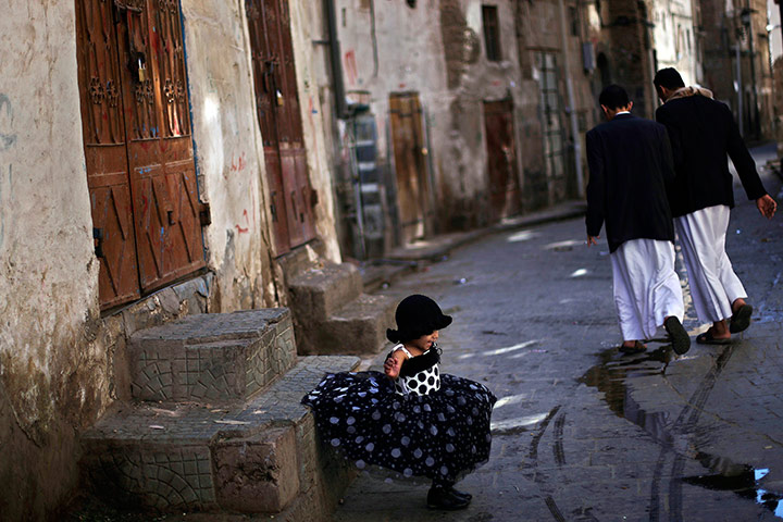 24 hours in pics: A young Yemeni girl jumps off the stairs in Sanaa, Yemen