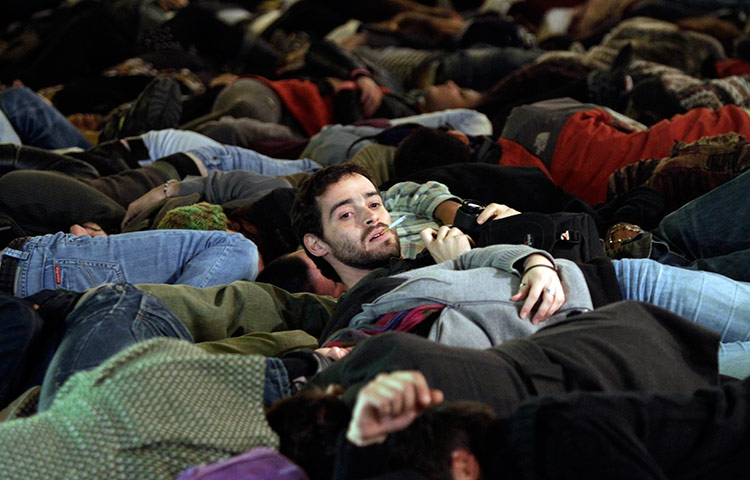 24 hours in pics: Anti-NATO demonstrators lay on the ground  Lisbon, Portugal, 