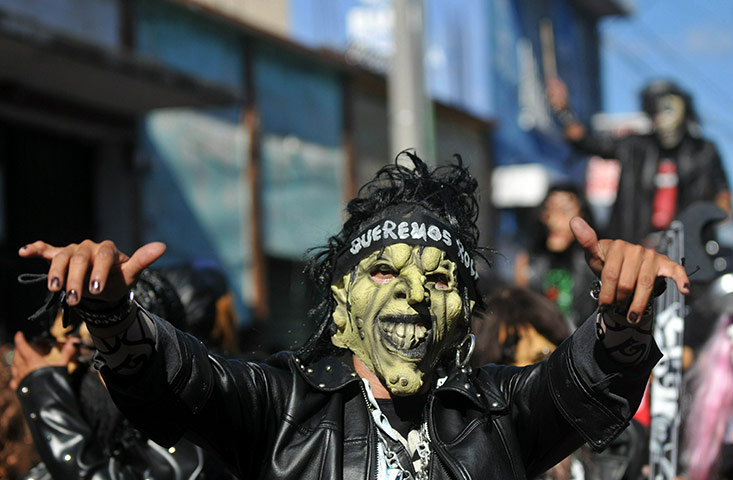 All Saints: Villa Nueva, Guatemala City: A reveller in costume dances 