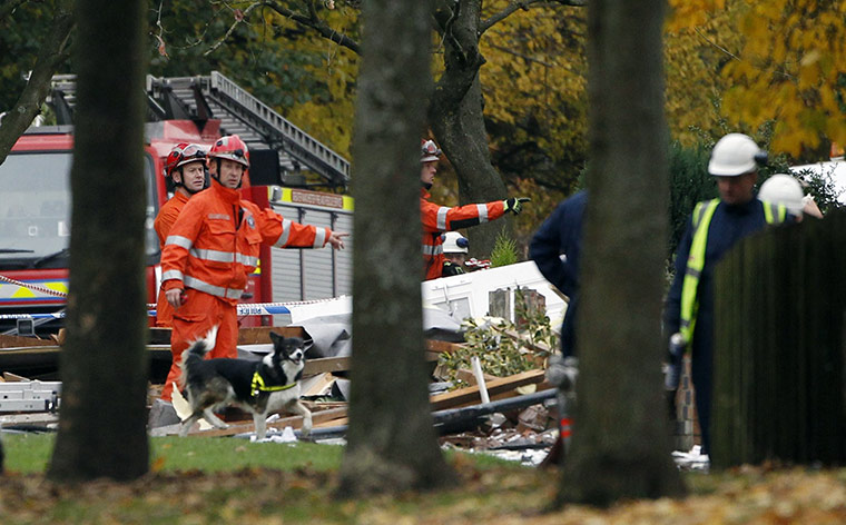 Salford gas explosion: A rescue team and dog search the scene of a suspected gas explosion