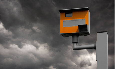 YELLOW GATSO ROAD SAFETY SPEED CAMERA AGAINST STORMY GREY SKY