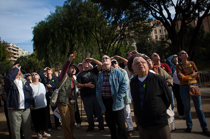 24 hours pics: A group of tourists look at the Sagrada Familia church, Barcelona