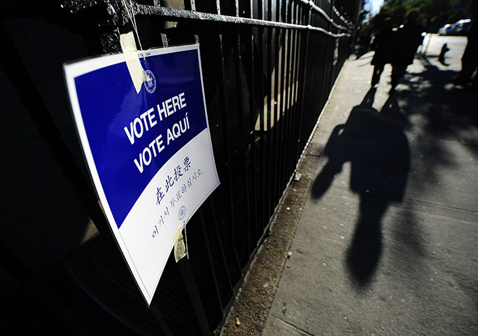 US midterm elections: Harlem, New York: A New York resident walks past a polling station