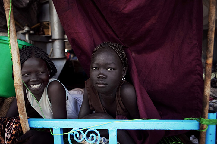24 Hours: Two southern Sudanese girls rest on board a boat bond for Juba