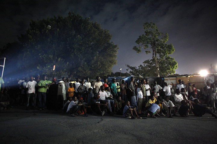 24 Hours: Haitians watch a movie in downtown Port-au-Prince