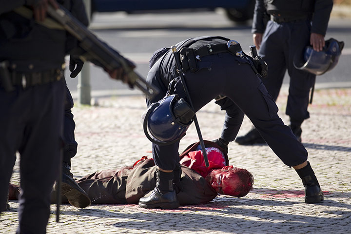 24 hours: Lisbon, Portugal: Police arrest a protester covered in red paint 