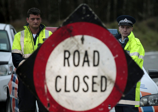 New Zealand mine: New Zealand police officers stand at a road block