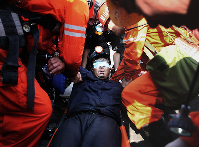 China's trapped miners: Rescuers put a trapped miner on a stretcher