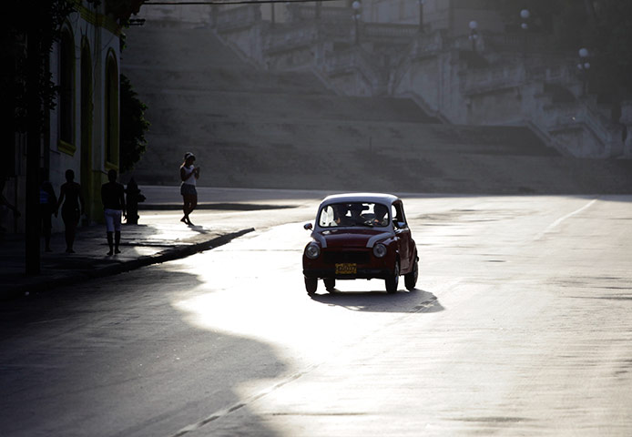 24 hours in pictures: A Fiat 600 car is driven on a street in Havana