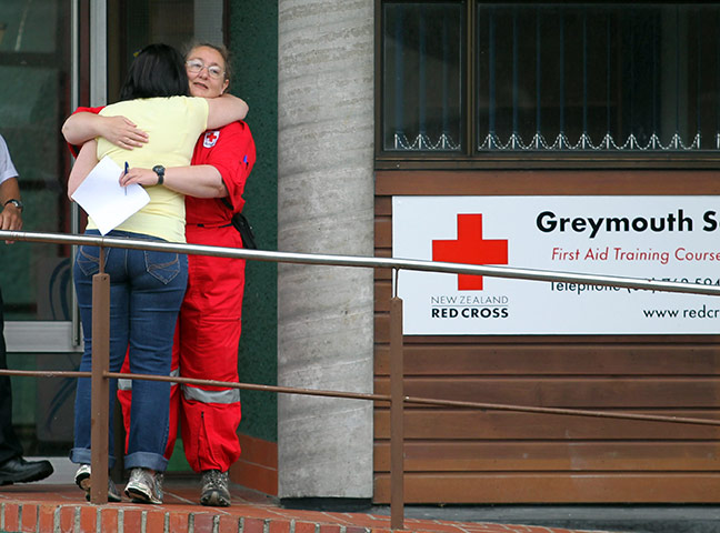 NZ miners: A Red Cross worker comforts a relative of a missing miner