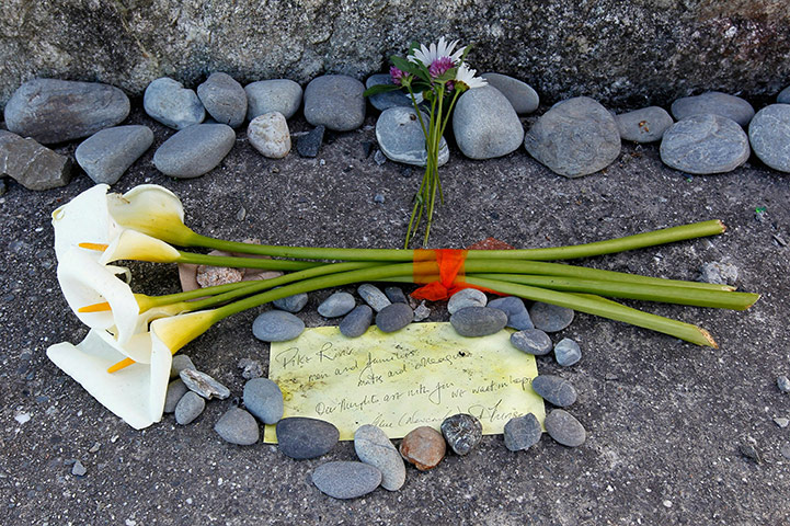 NZ miners: Flowers and a note lay at the foot of the Strongman Mine Memorial