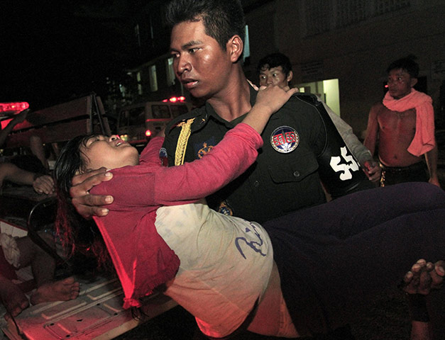 Cambodian stampeded: A stampede victim is carried to safety in Phnom Penh