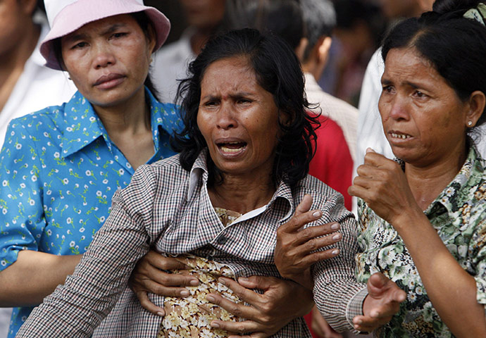 Cambodian stampeded: A woman, center, is consoled after her relative was confirmed dead 