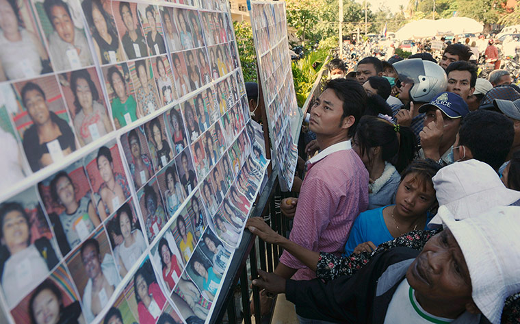 Cambodian stampeded: Pictures of victims of the stampede posted on a billboard outside