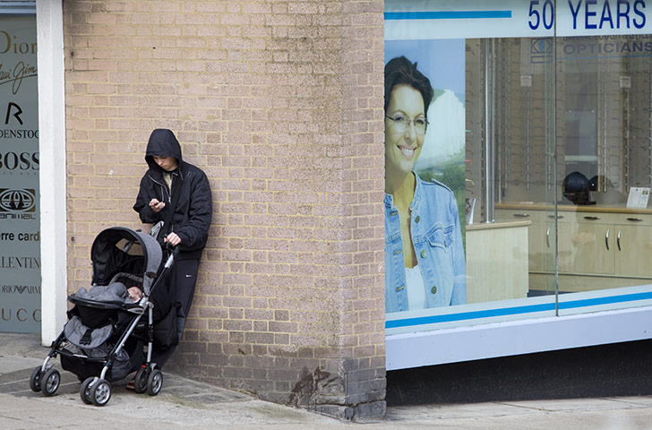 Spending Review 2010: A young parent with a baby in a buggy in Hastings.