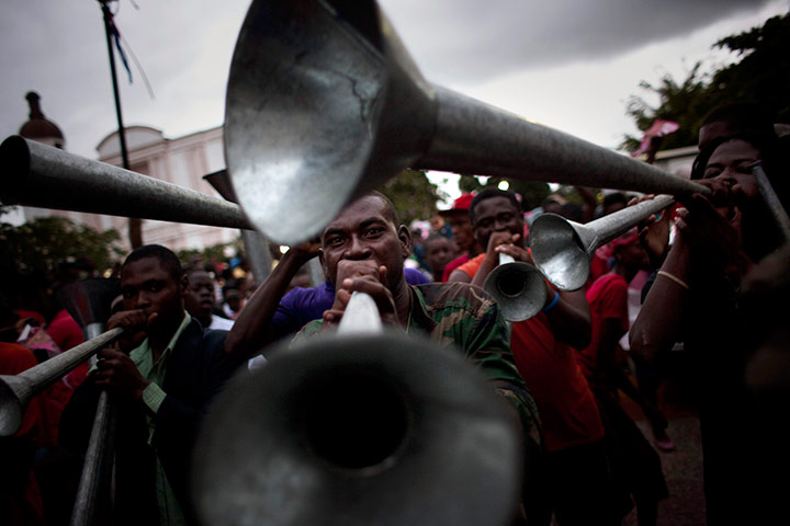 24 hours in pics: Supporters of Haitian presidential candidate Michel Martelly blow cornets