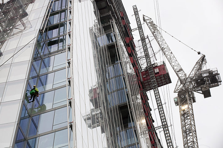 Tallest building: A man works on the side of The Shard