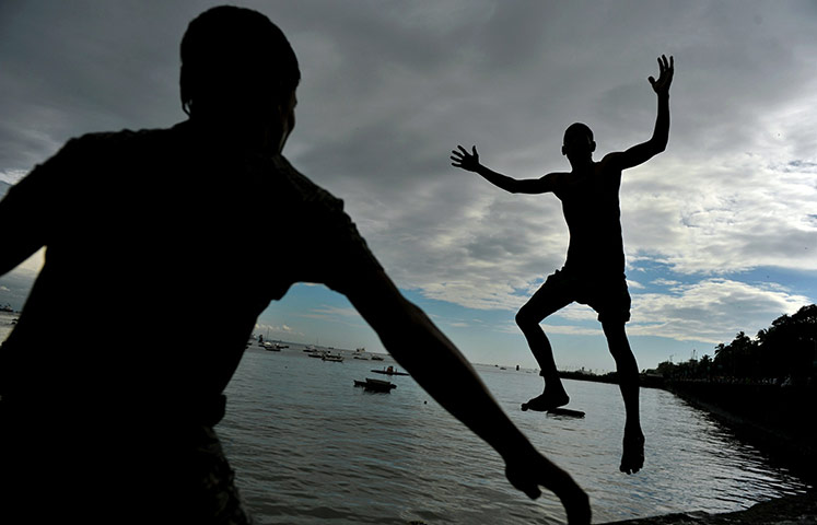 24 hours in pictures: An Indian boy does a somersault 
