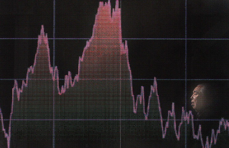 24 hours in pictures: electronic stock board of a securities firm in Tokyo