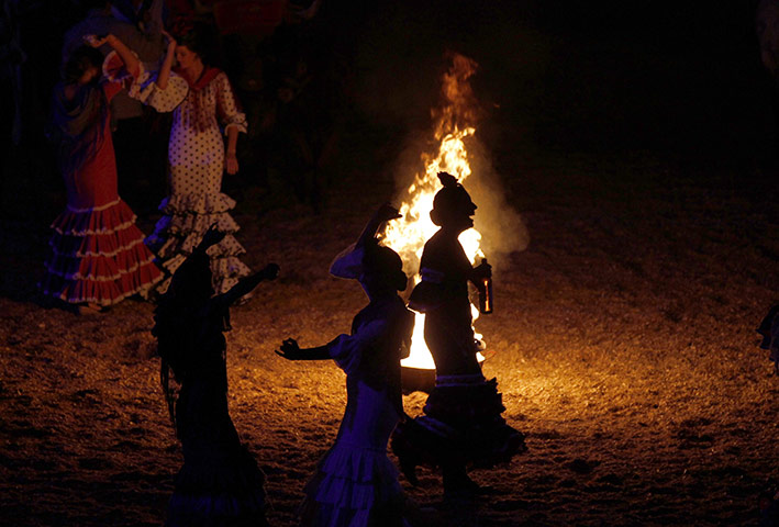 24 hours in pictures: Women wearing traditional Sevillana dresses