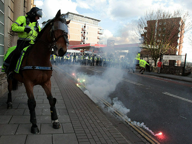 Student protests: Students protesters throw a firework at police in Bristol