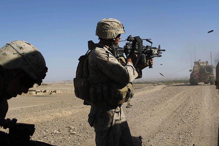 from the agencies: U.S. Marines fire weapons during a battle with taliban