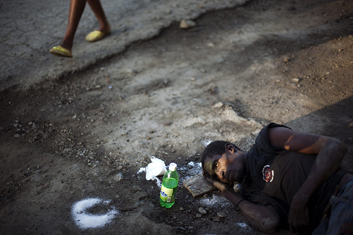 24 hours: Cap Haitien, Haiti: A man suffering from cholera lies by the road