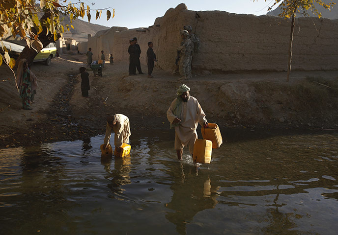 24 hours: West Now Ruzi, Afghanistan: Afghanis take water from a river