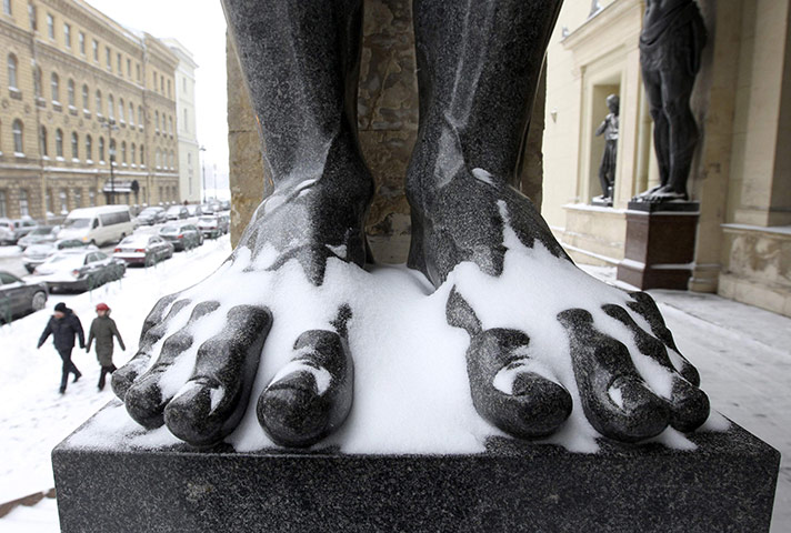24 hours: St. Petersburg, Russia: A couple walks on a street after snowfall 