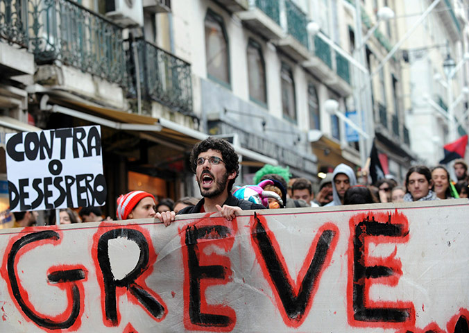 Business Week in Pictures: A protester holds a banner reading 