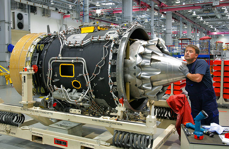 Business Week in Pictures: A Rolls-Royce employee assembles an aircraft engine at their