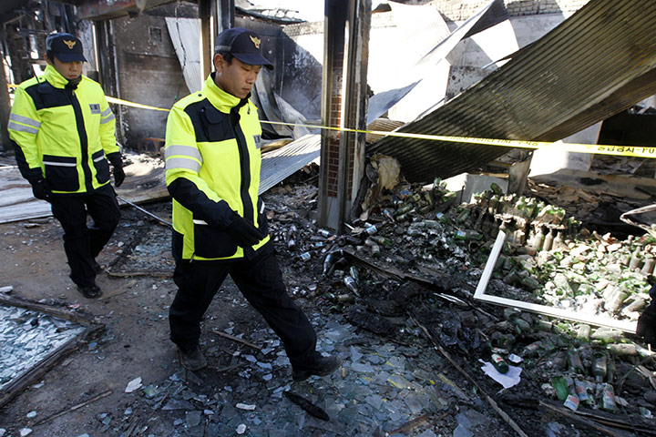 North Korea Update: Police officers patrol past houses destroyed by North Korean shelling