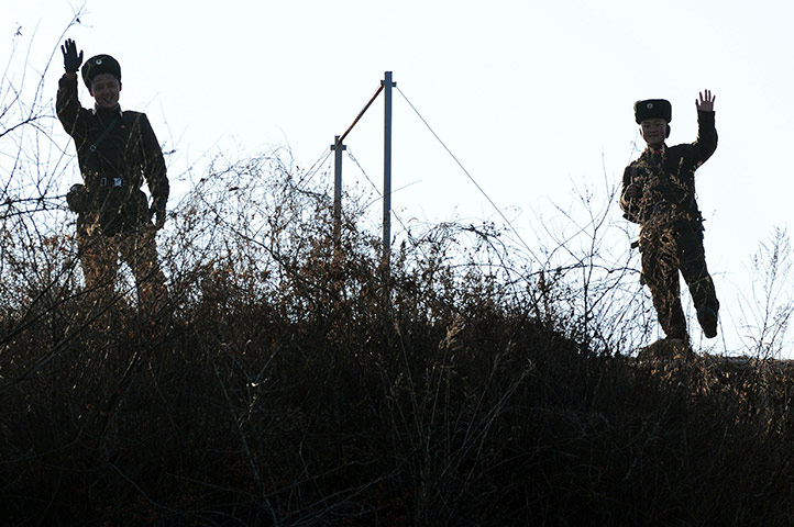North Korea Update: Armed North Korean soldiers wave to pass
